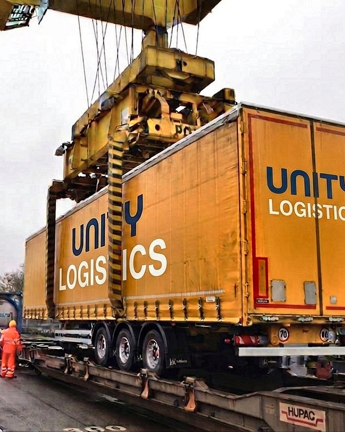 Unity Logistics curtainsider being lifted onto a rail wagon at an intermodal terminal